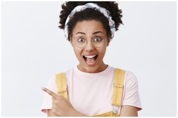 Happy, excited African American woman pointing left