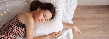 Young brunette woman sleeping comfortably while wearing beeswax earplugs