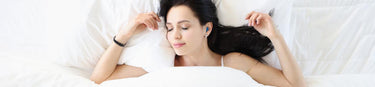 Sleeping woman wearing earplugs